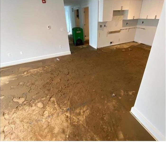 muddy, muck on floor, white walls, opened cabinets