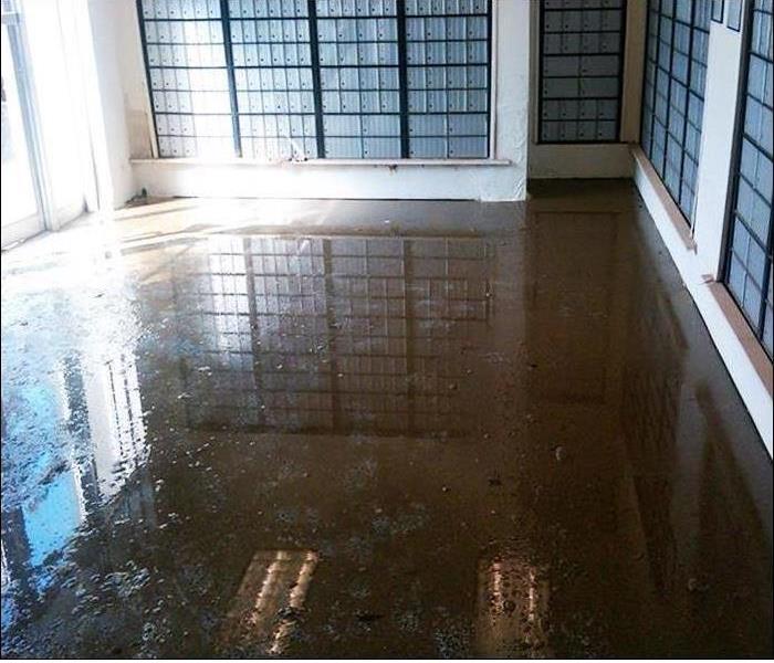 muddy water inside mail room covering the floor