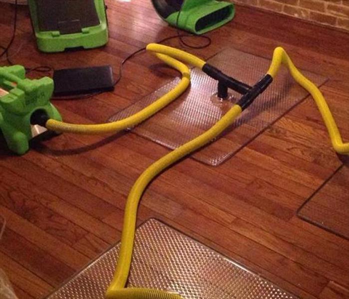 mats, hoses equipment on brown hardwood floor