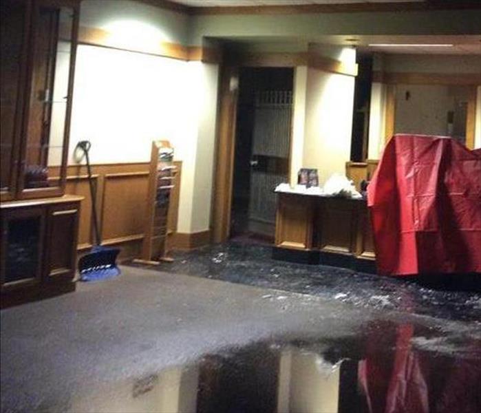 flooded carpet in bank, red tarp on equipment and furnishings