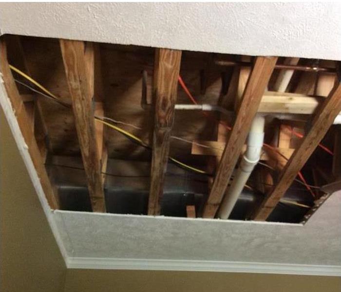 removed ceiling showing framing and plumbing