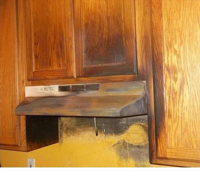 charcoal burned cabinet and hood in kitchen
