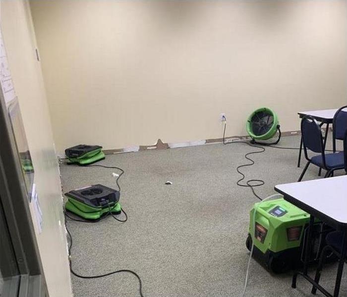 SERVPRO restoration equipment being used to dry water damaged commercial room